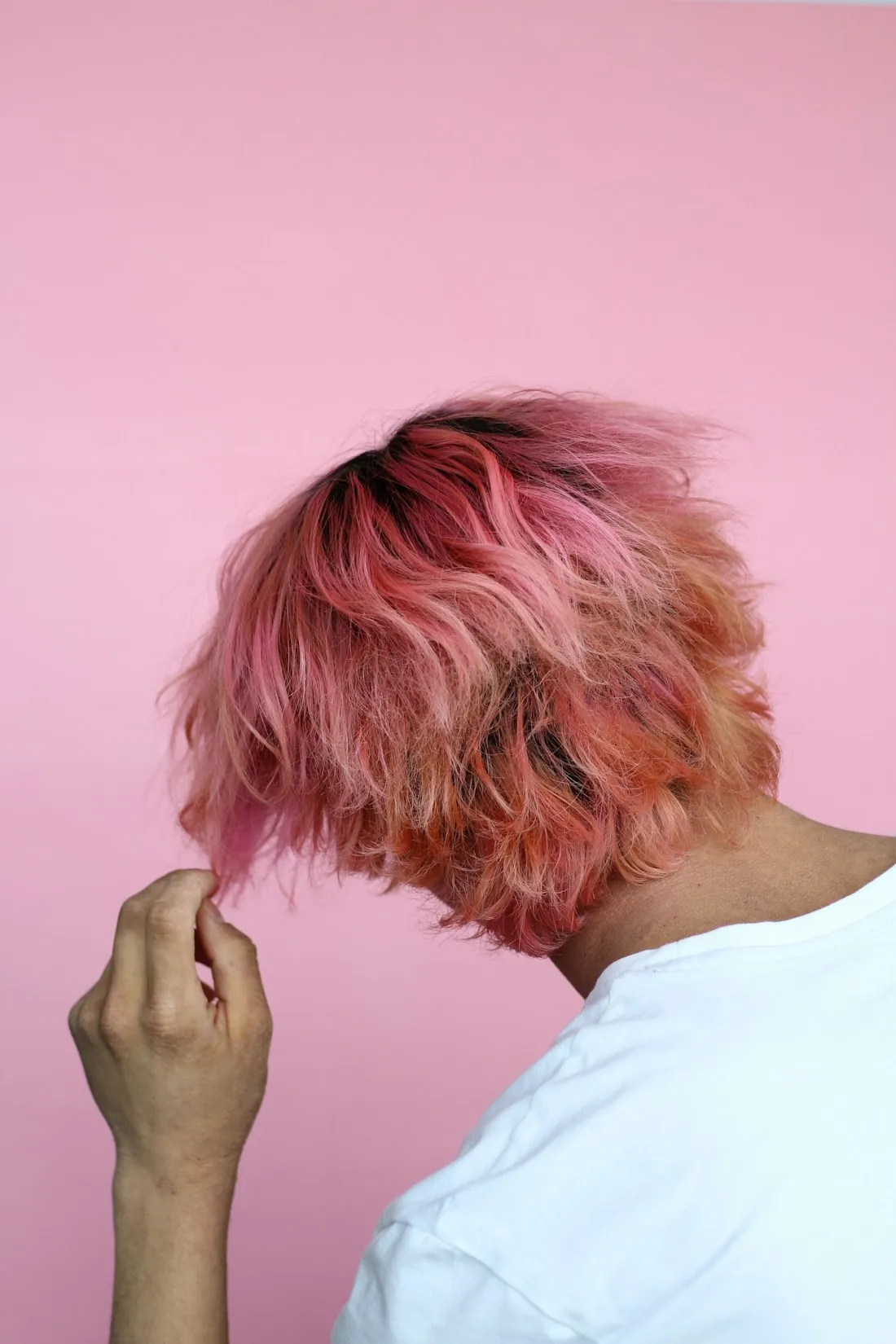 Vivid pink color being applied to a client's hair